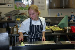 female chef cooking in kitchen