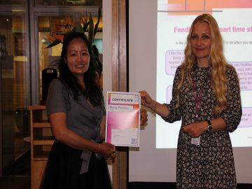 Certificate being handed to student Mercy Romero