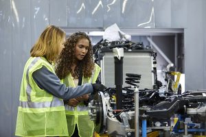 two females in high vis jackets with engineering machinery