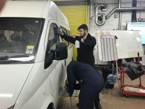 Alex and Josh working on cleaning up the minibus